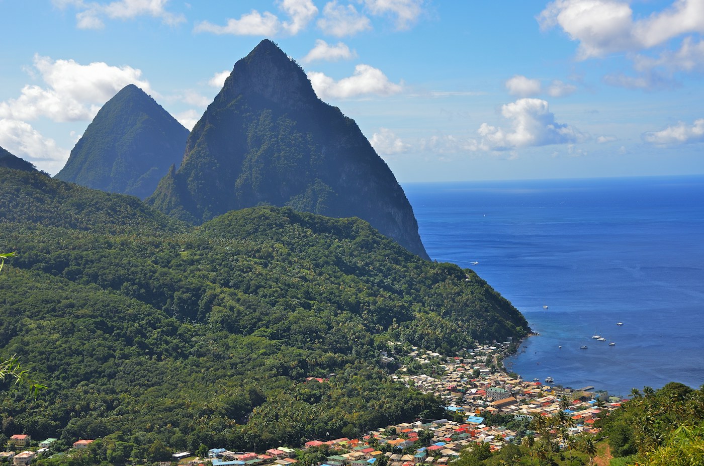 Saint Lucia’s Pitons rising above a green coastline and blue Caribbean sea